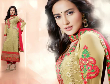 A stunning HD wallpaper featuring Indian celebrity Neha Sharma in traditional national dress, showcasing intricate embroidery and elegant styling against a soft background.