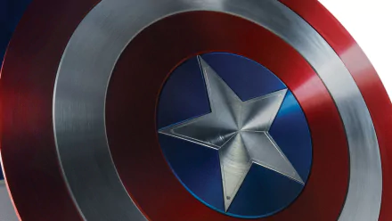HD desktop wallpaper featuring Captain America's iconic shield with a silver star centerpiece, red and silver concentric circles, and a blue background.
