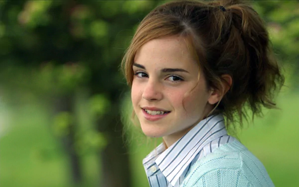 HD wallpaper of Emma Watson smiling in a natural setting, perfect for desktop background use.
