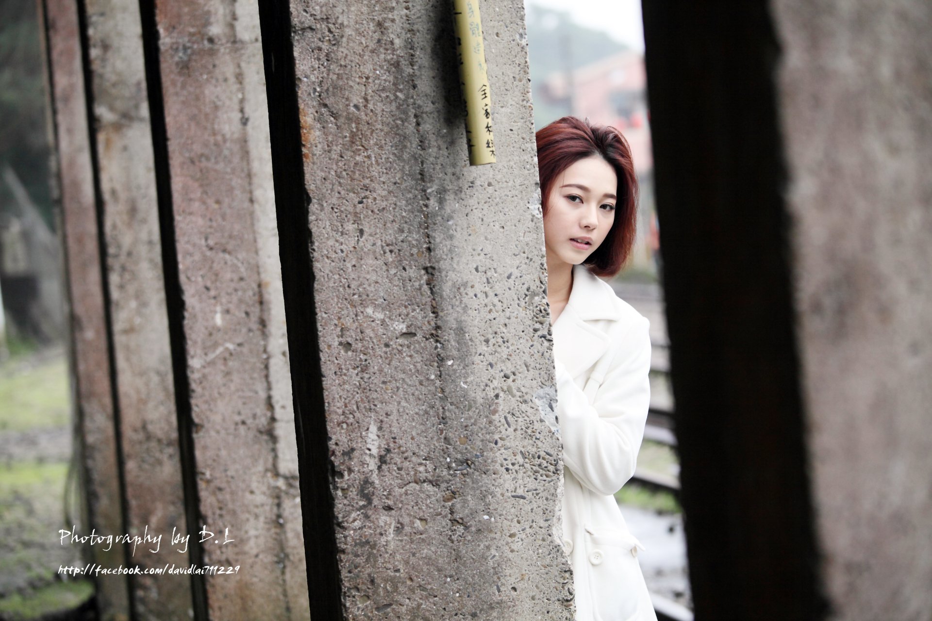 A 4K Ultra HD desktop wallpaper featuring Taiwanese Asian model Lín Yǔ peeking from behind a weathered concrete pillar in an outdoor setting.