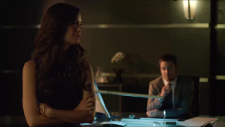 HD desktop wallpaper featuring Isabel Rochev and Summer Glau from the TV show Arrow, capturing a dimly lit, tense indoor scene.