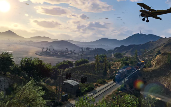 A stunning HD wallpaper from Grand Theft Auto V, featuring a picturesque landscape with mountains, a train on the tracks, and a plane soaring overhead against a vibrant sky.