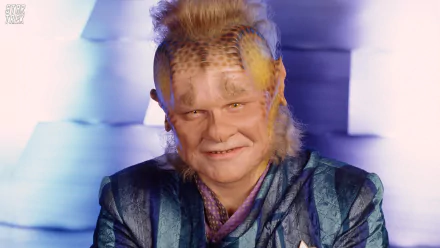 HD desktop wallpaper featuring Ethan Phillips as Neelix from the TV show Star Trek: Voyager, showcasing his distinctive alien makeup and colorful costume.