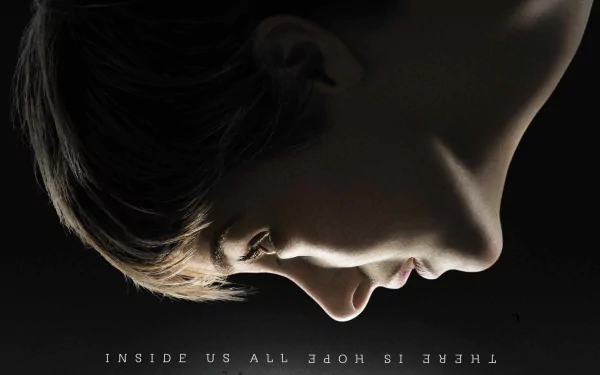 Close-up side profile of a person against dark background with the phrase THERE IS HOPE INSIDE US ALL in this 4K Ultra HD PC desktop wallpaper inspired by the movie Insurgent.