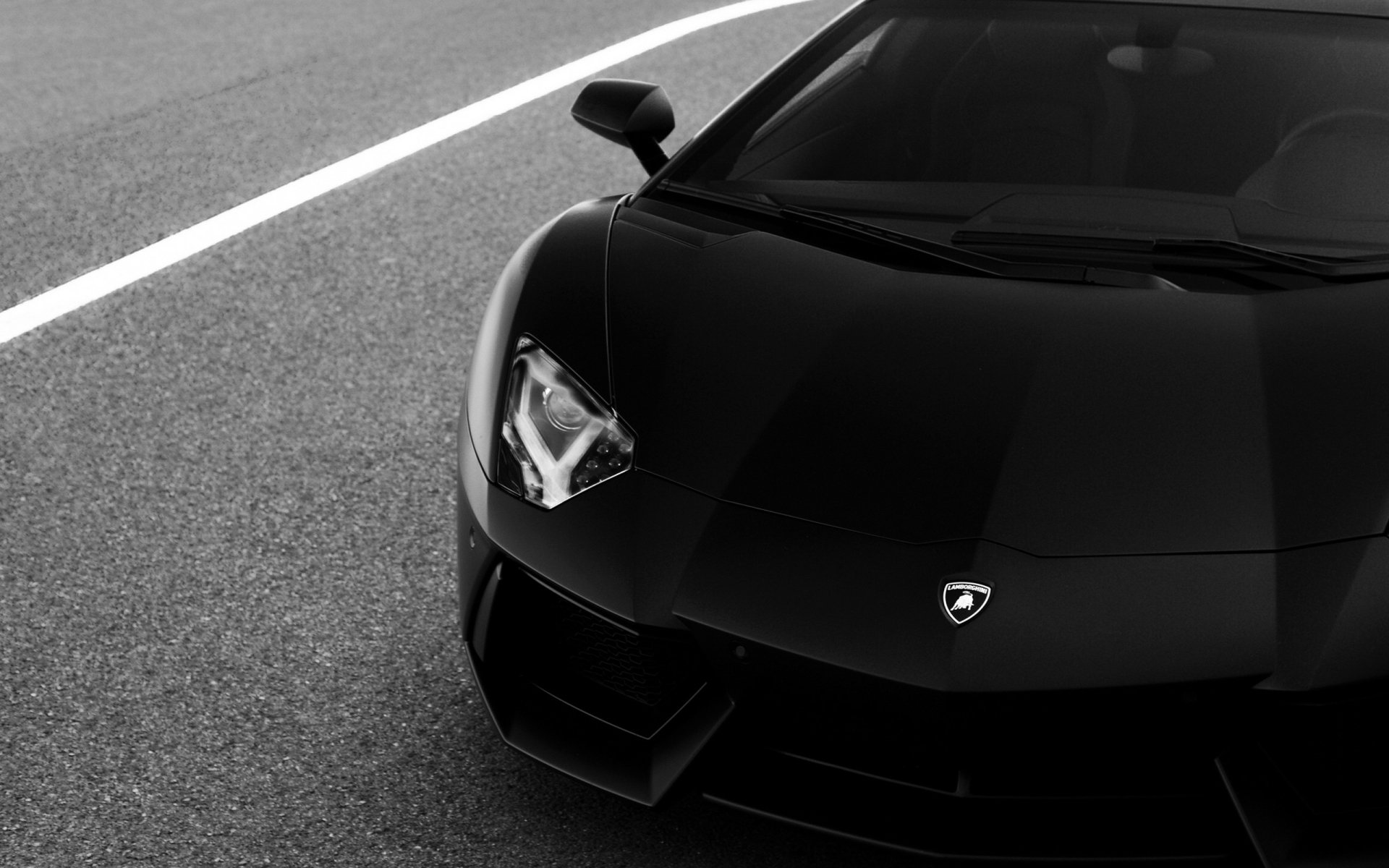 Black Lamborghini Aventador sports car on asphalt, captured in a sleek, high-definition PC desktop wallpaper background.