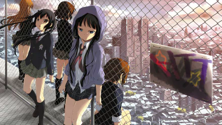 Anime characters Ritsu Tainaka, Azusa Nakano, Tsumugi Kotobuki, Yui Hirasawa, and Mio Akiyama are depicted in school uniforms against a cityscape backdrop in this vibrant K-ON! wallpaper.