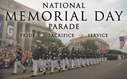 Memorial Day holiday 2K Quad HD PC desktop background: uniformed servicemembers marching in a National Memorial Day parade past crowds, flags and classical buildings.