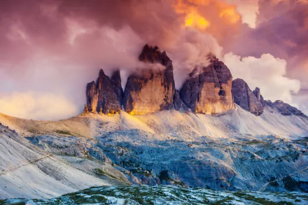 Majestic view of the Tre Cime di Lavaredo in the Dolomites, South Tyrol, Austria, showcasing dramatic peaks against a colorful, cloudy sky in stunning 4K Ultra HD.