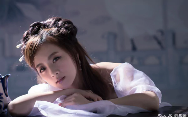 Portrait of an Asian woman from Taiwan with intricate hair-dress, captured in a serene 4K Ultra HD image for PC desktop wallpaper and background.