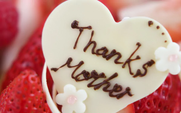 HD desktop wallpaper featuring a heart-shaped white chocolate with Thanks Mother written on it, surrounded by strawberries, celebrating Mother's Day.