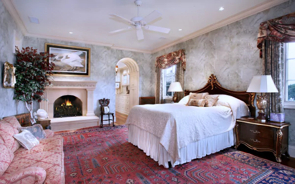 A 4K Ultra HD interior view of a stylish bedroom featuring classic furniture, a fireplace, ornate curtains, and a large rug, creating a cozy and elegant man-made room.