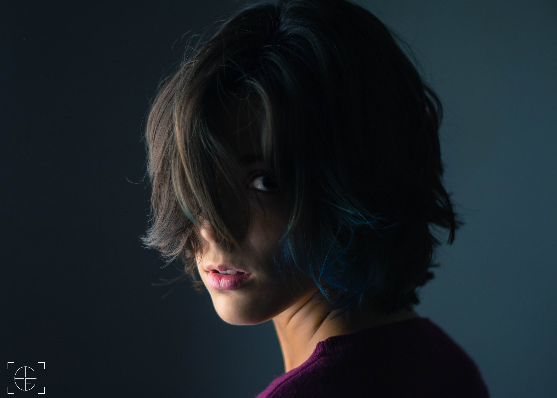 Close-up 4K Ultra HD wallpaper of a woman with tousled hair partially covering her face, capturing a mysterious and moody atmosphere.