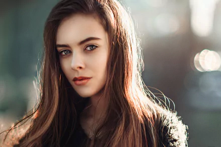 A captivating portrait of a woman with long hair, featuring soft bokeh effects that enhance her striking features, making it a stunning HD background.
