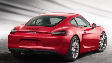Red Porsche Cayman GTS sports car, rear three-quarter view on a neutral gray backdrop — HD PC desktop wallpaper featuring a Porsche Cayman vehicle.