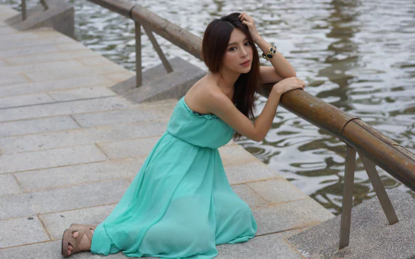Taiwanese model Julie Chang, also known as Zhang Qi Jun, poses by the water wearing a flowing turquoise dress and bracelet in this 4K Ultra HD desktop wallpaper.