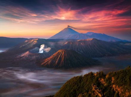 A stunning view of Mount Bromo in Indonesia captures the majestic volcanic landscape, bathed in vibrant colors at sunset, showcasing the beauty of nature.