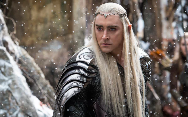 A scene from The Hobbit: The Battle of the Five Armies, featuring a character with long hair and ornate armor amidst falling snow, captured in a high-definition desktop wallpaper.