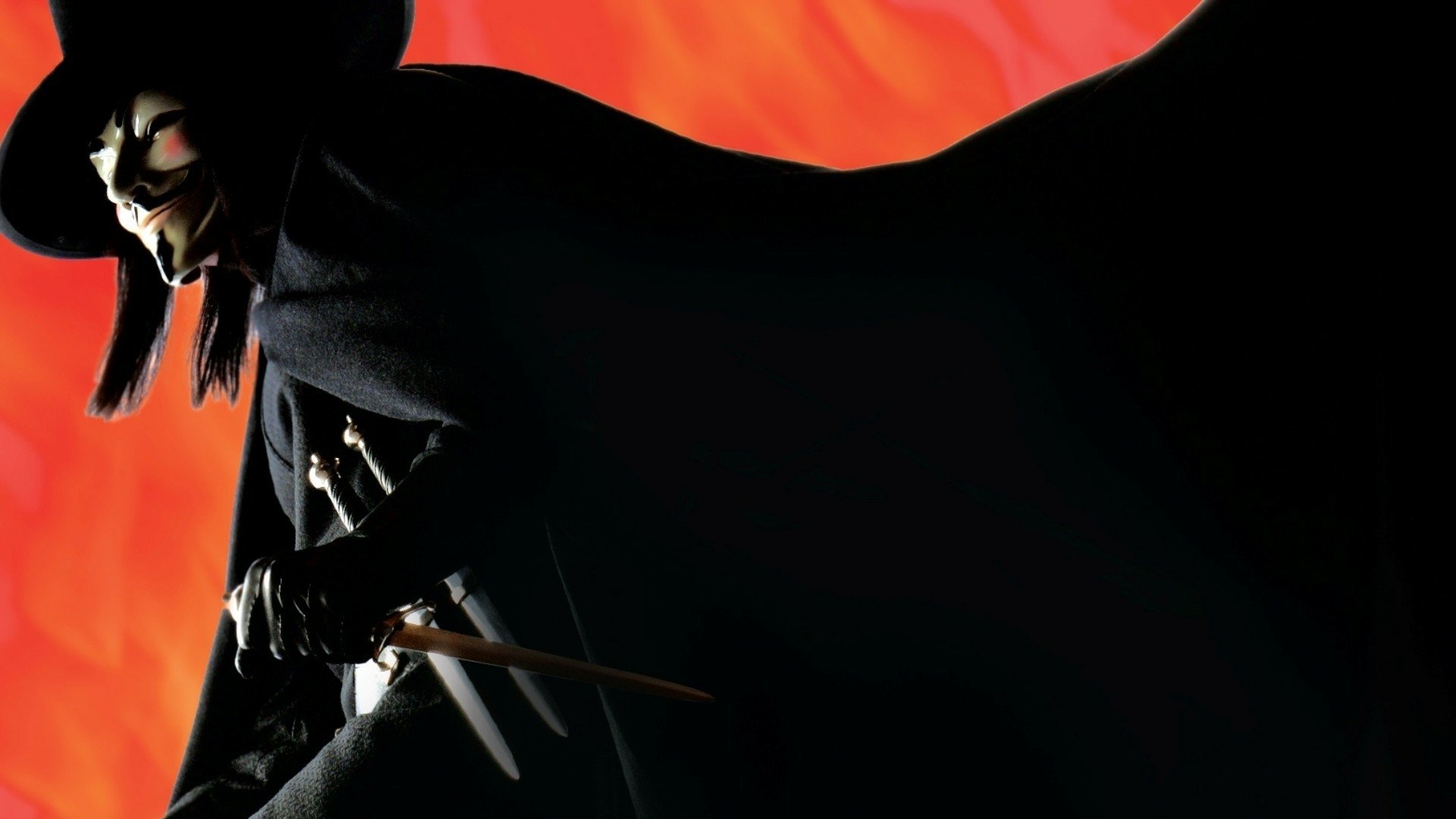 HD PC desktop wallpaper of V from V for Vendetta: masked Guy Fawkes figure in a black cloak, dagger raised against a blazing red-orange background.