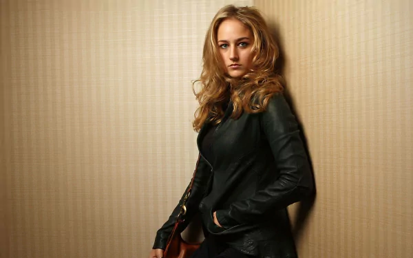 HD PC desktop wallpaper featuring Leelee Sobieski from the movie Walk All Over Me, showcasing her in a black leather jacket against a neutral textured background.