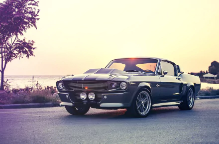 HD PC desktop wallpaper featuring a classic Ford Mustang Shelby Cobra GT 500 parked on a scenic road at sunset.
