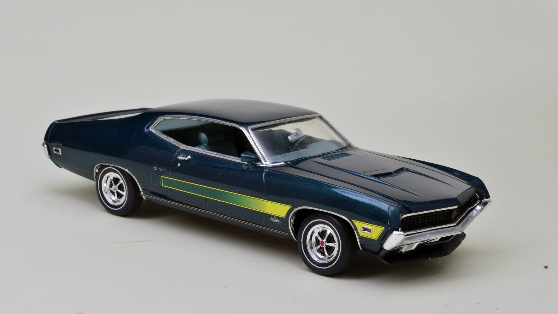 Dark blue Ford Torino GT muscle vehicle on a neutral backdrop — 5K Ultra HD PC desktop wallpaper and background.