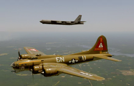A Boeing B-17 Flying Fortress flies below a Boeing B-52 Stratofortress over a landscape, captured in a 4K Ultra HD military-themed PC desktop wallpaper.