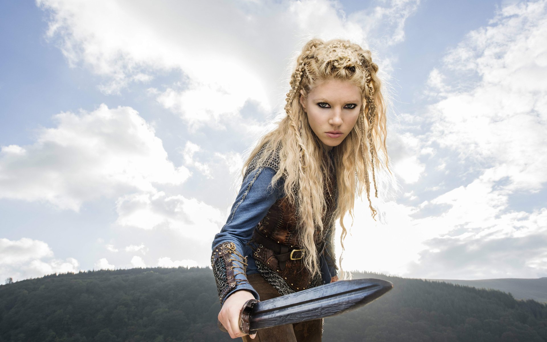 HD desktop wallpaper of Lagertha from the TV show Vikings (2013), portrayed by Katheryn Winnick, standing outdoors with a shield and intense expression.