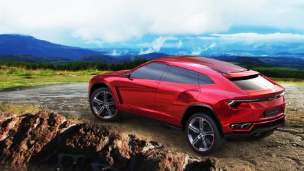 A striking red Lamborghini Urus concept car parked on rugged terrain, set against a backdrop of mountains and cloudy skies. High-resolution 4K Ultra HD wallpaper.