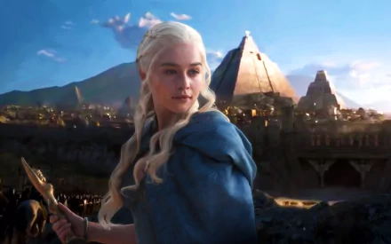 HD desktop wallpaper featuring Emilia Clarke as Daenerys Targaryen from the TV show Game of Thrones, with a dramatic backdrop of pyramids and an evening sky.

