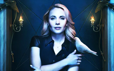 Image of Leah Pipes from the TV show The Originals, featuring a dramatic background with candles and a white dove perched on her arm. Ideal HD wallpaper for fans.