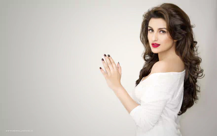 A stunning HD wallpaper featuring celebrity Parineeti Chopra, showcasing her elegant pose and stylish look against a soft, neutral background.