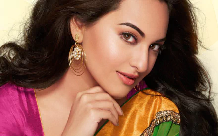 HD desktop wallpaper featuring celebrity Sonakshi Sinha, showcasing her in a vibrant saree with intricate earrings and subtle makeup.