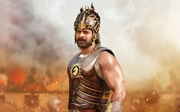 HD PC desktop wallpaper featuring Prabhas as a warrior from the movie Baahubali: The Beginning, dressed in detailed armor with a dramatic smoky background.