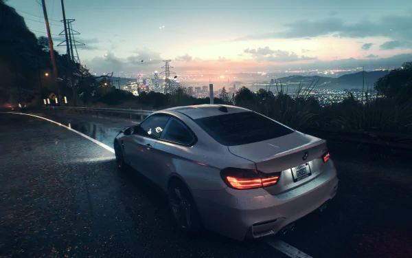 A sleek silver car from Need For Speed (2015) navigates a winding road at sunset, with a vibrant city skyline glowing in the background, creating a stunning HD wallpaper.