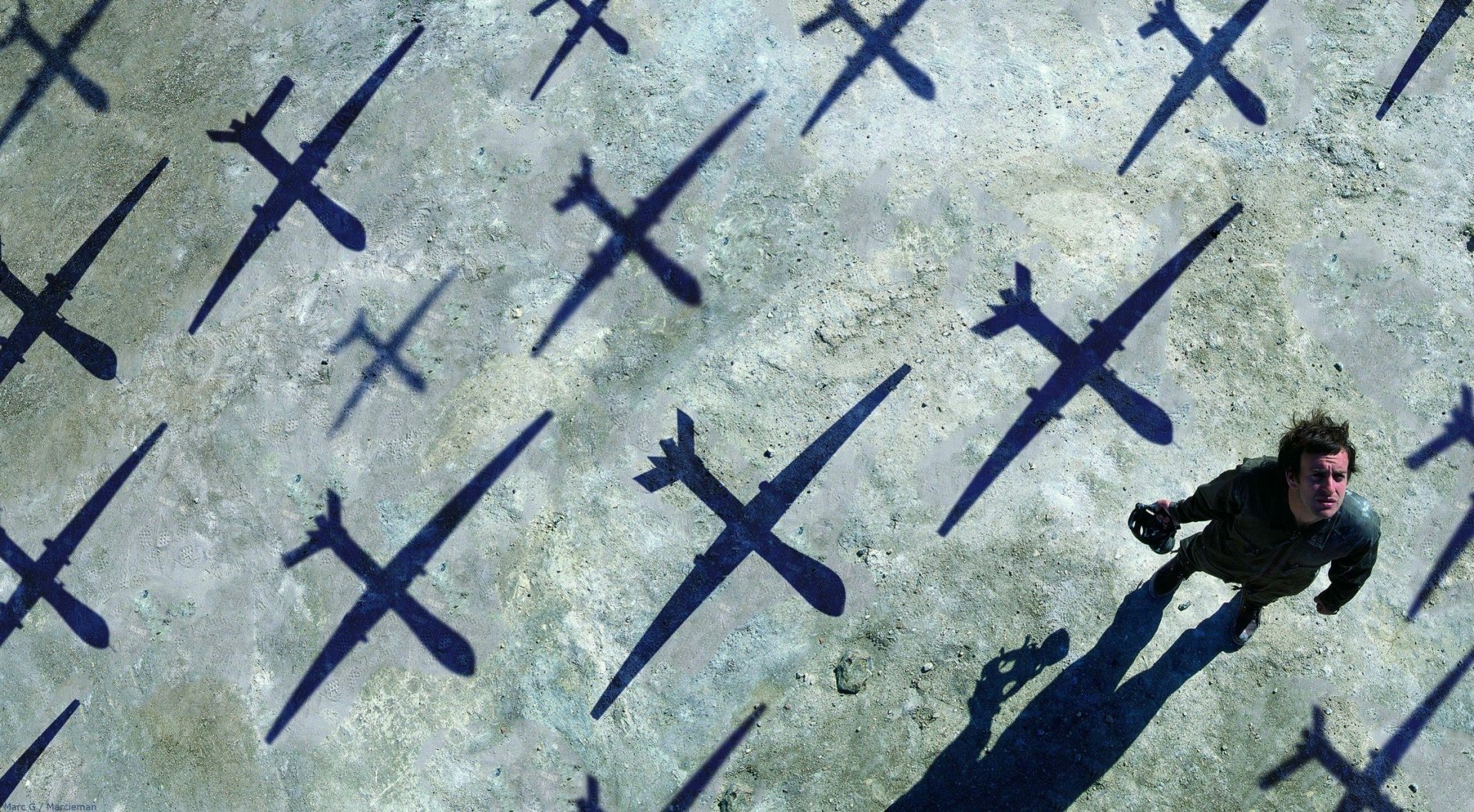 A stunning HD desktop wallpaper featuring a dramatic scene with shadows of planes cast on a ground, evoking themes of music and artistry reminiscent of Muse.