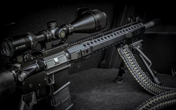 A close-up of a black rifle with a scope, showcasing its detailed design and features, set against a dark background. This high-definition image serves as a striking desktop wallpaper.