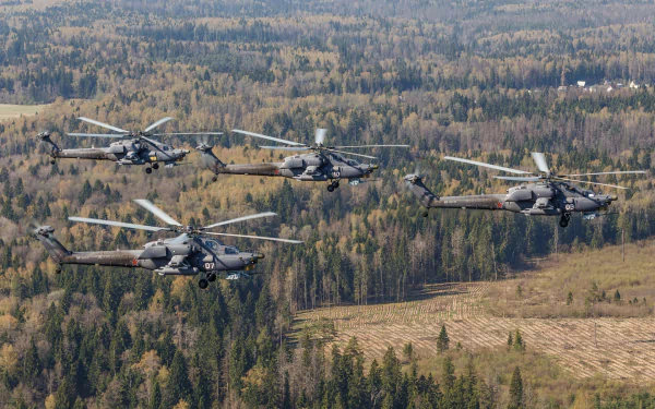 HD desktop wallpaper featuring four Mil Mi-28 military helicopters flying over a dense forest landscape.