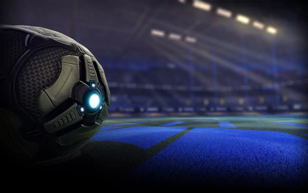 HD wallpaper featuring a close-up of the Rocket League soccer ball with a futuristic design on a dimly lit stadium field, providing an immersive gaming atmosphere for Rocket League fans.