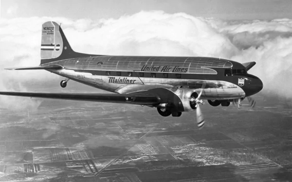 Black and white HD desktop wallpaper showcasing a Douglas DC-3 aircraft flying above the clouds, representing a classic vehicle in aviation history.