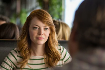 Red-haired woman in a striped shirt smiles across a diner booth — HD movie still from Irrational Man, desktop wallpaper.