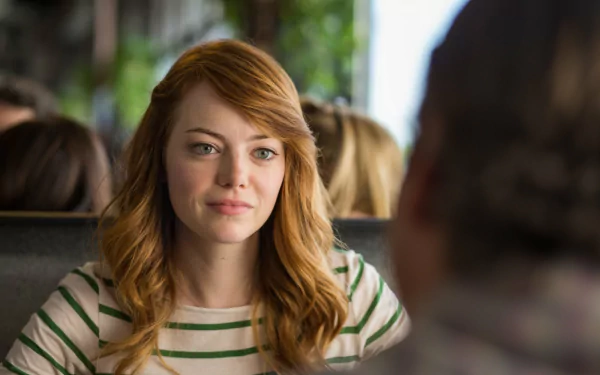 Red-haired woman in a striped shirt smiles across a diner booth — HD movie still from Irrational Man, desktop wallpaper.