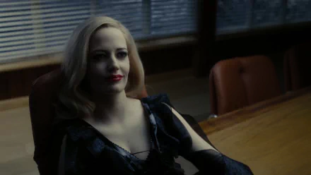 Eva Green in a striking scene from the movie Dark Shadows, showcasing her captivating presence and elegance against a backdrop of modern office decor. HD desktop wallpaper.