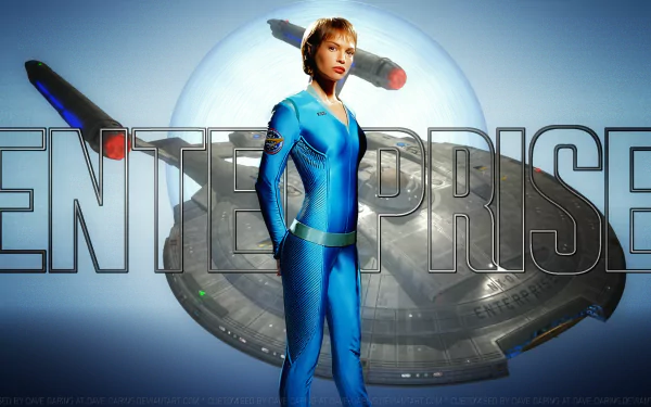Jolene Blalock as T'Pol from Star Trek: Enterprise stands in front of the starship Enterprise in this HD PC desktop wallpaper background.