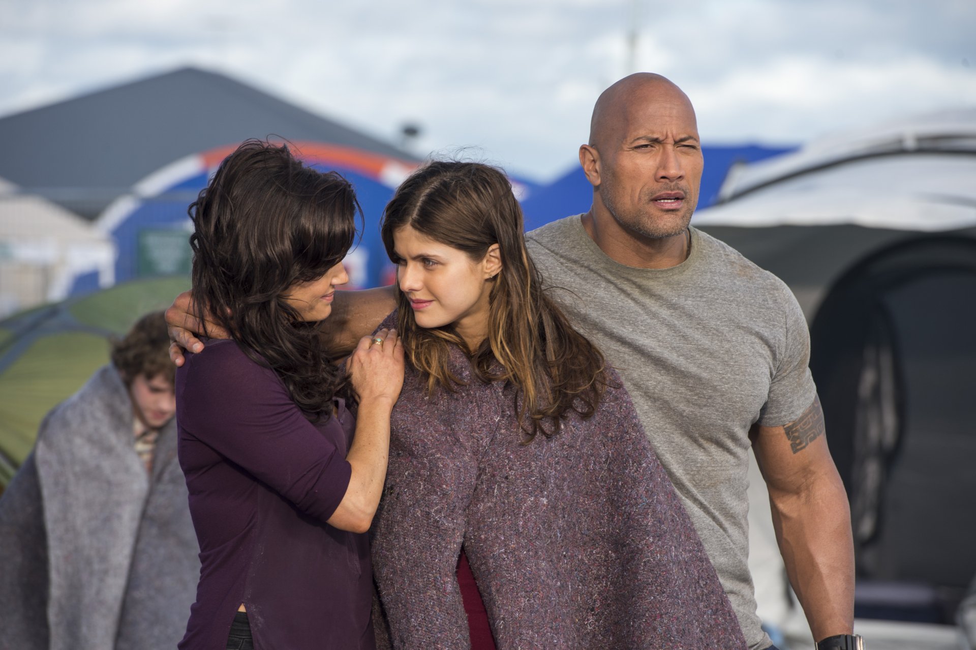 Dwayne Johnson, Alexandra Daddario, and Carla Gugino share a tense moment in a scene from the movie San Andreas, captured in this striking HD desktop wallpaper.