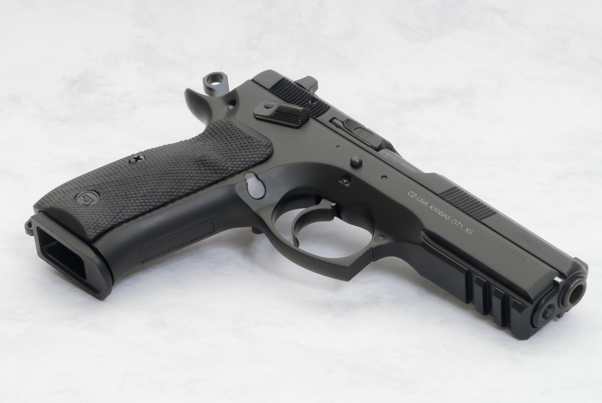Man-made CZ 75 SP-01 pistol photographed on a light surface, presented as a 2K Quad HD PC desktop wallpaper and background.