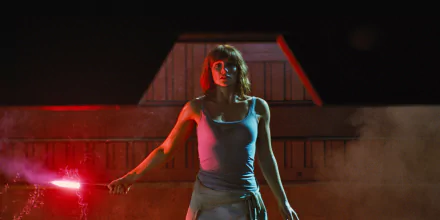 Bryce Dallas Howard in a dramatic scene from Jurassic World, featured in a HD PC desktop wallpaper and background with intense red lighting.