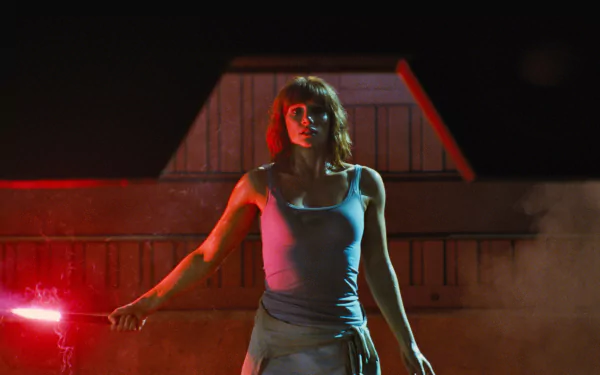Bryce Dallas Howard in a dramatic scene from Jurassic World, featured in a HD PC desktop wallpaper and background with intense red lighting.
