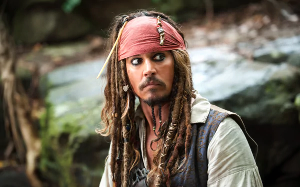 Portrait of Jack Sparrow, played by Johnny Depp, from Pirates of the Caribbean: On Stranger Tides, showcasing his signature look and adventurous spirit in a lush outdoor setting.