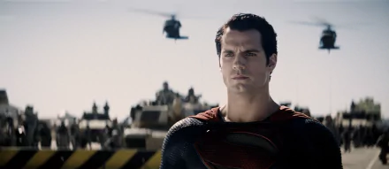 Superman, portrayed by Henry Cavill, stands resolutely amid helicopters, captured from the film Man of Steel, set against a dramatic sky in this HD desktop wallpaper.