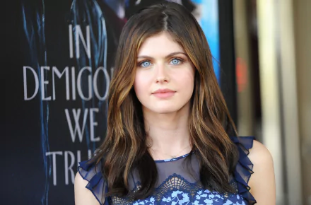 HD desktop wallpaper featuring celebrity Alexandra Daddario, showcasing her standing in front of a promotional poster.